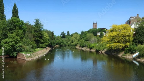 The River Exe flowing through the small Devon town of Tiverton with St Paul's Anglican church