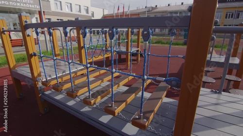 Empty balancing path stands ready for active children during school break. Safe design elements create engaging environment for play