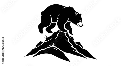 Silhouette of a bear atop a mountain peak, symbolizing nature and strength.