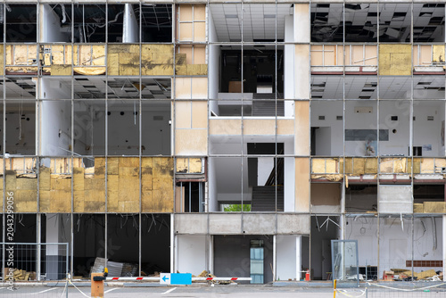 Damaged Office Building Facade Under Demolition and Renovation