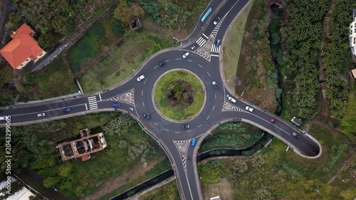 Aerial top-down view of traffic on a roundabout in Funchal, Madeira Island, Portugal.	
