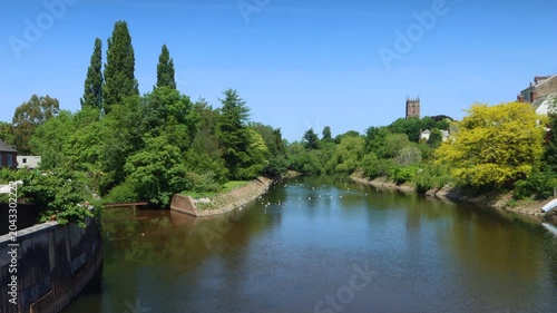 The River Exe flowing through the small Devon town of Tiverton with St Paul's Anglican church