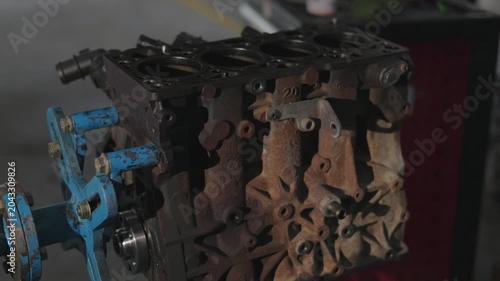 Vintage combustion engine component in a mechanics workshop.Coroded metal cylinder block during car maintenance service.