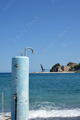 An old abandoned showering facility, with an old abandoned quarry out of focus at a distance in Euboea, Greece