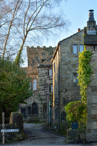 Church Lane in Heptonstall village with beautiful old stone housed in front of the historic medieval ruins of St Thomas a Becket church