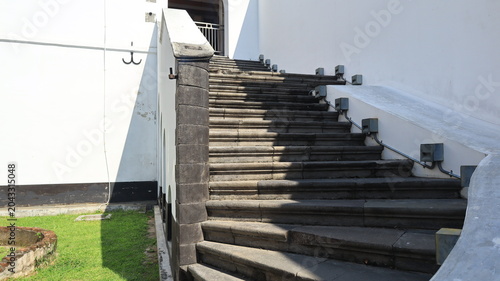 Bild auf Leinwand A beautiful gray stone staircase complements an old building