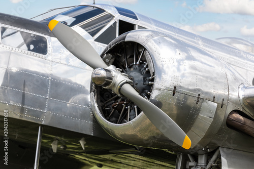 Canvas Print Close-up  detail polished vintage aircraft engine propeller reflective aluminum fuselage riveted metal panels
