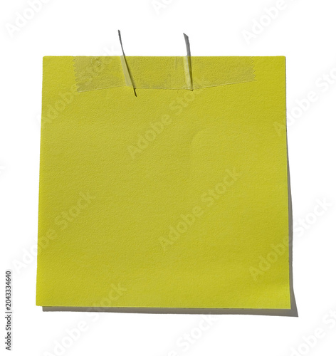 Yellow sticky note with tape isolated on black background, shadow