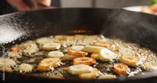 Garlic Sizzling in Hot Oil in Cooking Pan