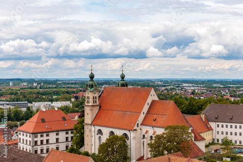 Valokuva Panoramic view of Landsberg am Lech with the historic Heilig Kreuz church, beautiful baroque monastery building with twin onion domes and red tile roofs under a dramatic cloudy sky, Bavaria, Germany