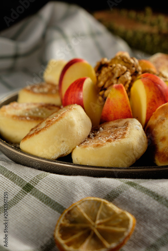 Delicious Ukrainian cottage cheese pancakes with fresh apples and walnuts