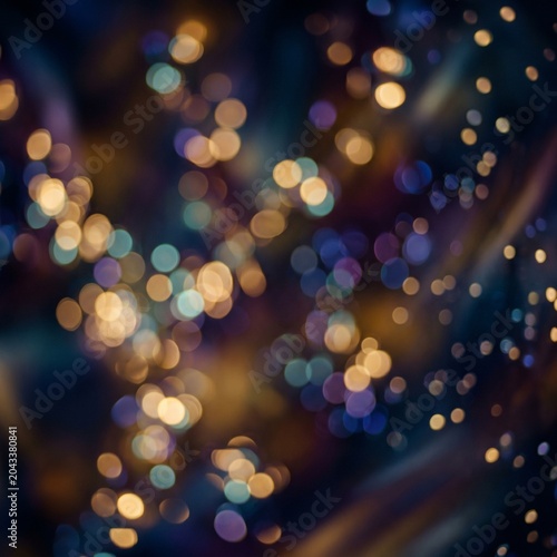 Abstract colorful bokeh lights creating a blurry circle pattern background.