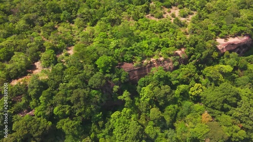 Drone video of the Attapeu valley landscape as seen from near Khamtay Cave, Attapeu Province, Laos. The aerial view captures the vast agricultural plain with rice fields in various stages of cultivati
