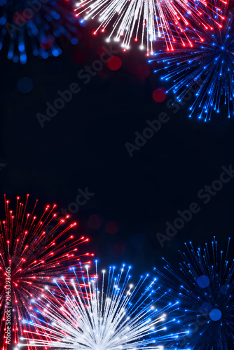 Vertical vibrant red and blue fireworks background with glowing bokeh lights for smartphone wallpaper and patriotic mobile social media independence day content.