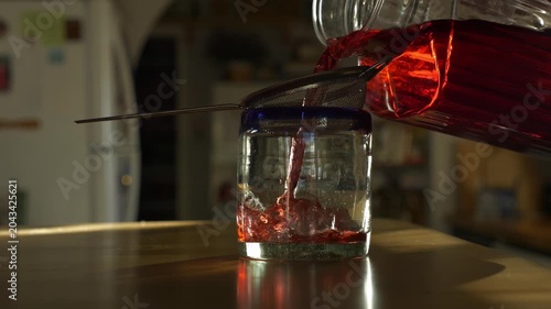 A man pours a glass of healthy Hibiscus tea