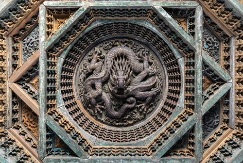 Ancient Chinese wooden caisson ceiling carved in the shape of a Chinese dragon