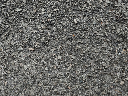 Billede på lærred Closeup of asphalt surface with gravel texture and hardened tar layer