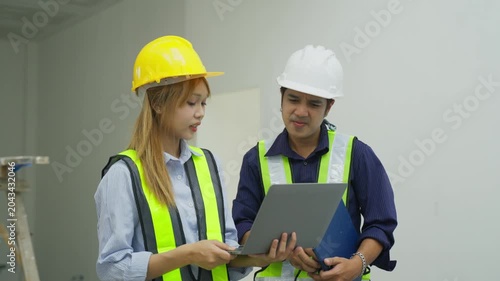 Construction site engineer worker hard hat safety vest laptop inspection teamwork industrial planning project building interior warehouse supervision consultation site management work safety process