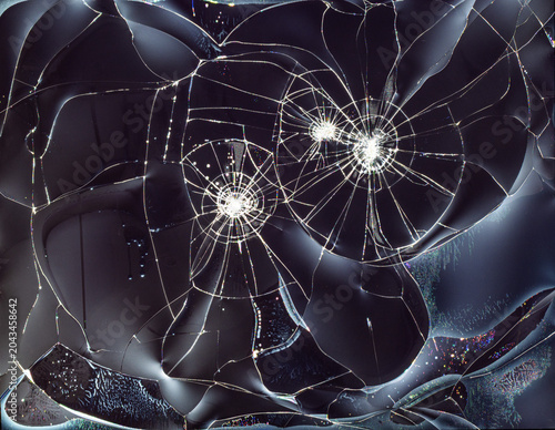 A shattered TV or monitor screen displaying impact marks and radial cracks spreading from central strike points