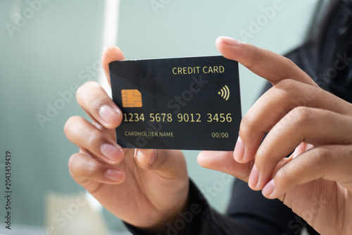 Tableau sur toile Close-up of hands holding a contactless credit card for digital payment