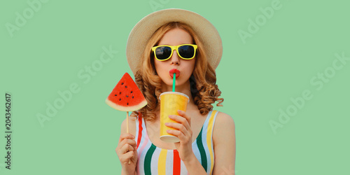Summer colorful portrait of beautiful young woman drinking juice with lollipop watermelon