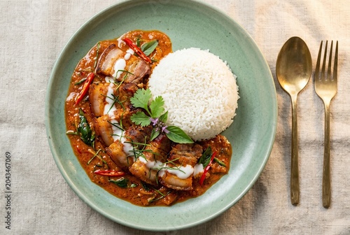 Generated AI set photos featuring a mouthwatering Thai red curry with crispy pork belly served alongside warm jasmine rice
