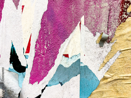 Vintage old posters stuck and torn on the wall in your grunge background