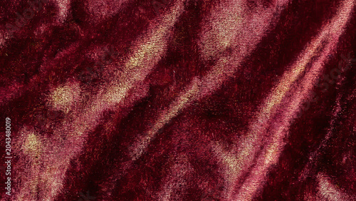 Shimmering Crushed Burgundy Velvet Fabric Texture With Golden Sheen Symbolizing Luxury and Elegance Perfect for Branding Advertising Background and Presentation Design