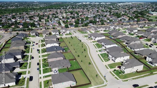 Linear greenbelt spine along Cottle Dr corridor forms open space between rows of homes in this suburban neighborhood. Shingled roofs, young trees even lighting produce smooth tones, Arlington, TX