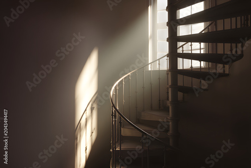 Ethereal light beams through a window illuminating an old spiral staircase, casting dramatic shadows and revealing dust particles in a timeless architectural setting.
