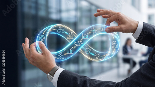 Continuous business process and innovation concept with glowing infinity loop in hands.