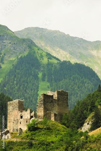 Tschanüff Castle, a ruined castle in the Alpine village of Ramosch. Valsot, Canton of Graubünden, Switzerland.