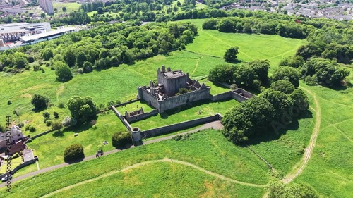 Majestic view of the historic medieval Craigmillar Castle in Edinburgh, Scotland. Beautiful stone fortress and museum architecture with ancient battlements and defensive walls, surrounded by lush gree
