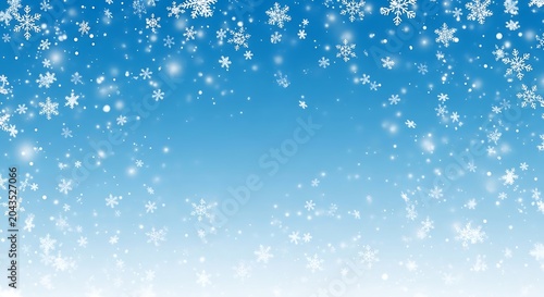 Winter background with falling snowflakes on a blue gradient