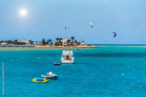 Yacht, kite surfers and a beautiful island and on the Red Sea in sunny day
