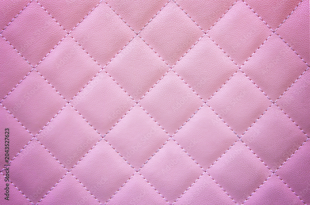 Naklejka premium Soft pink quilted texture with diamond pattern, creating a gentle and elegant background.