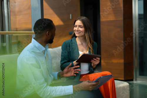 Diverse colleagues discussing business during a formal meeting