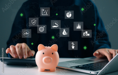 Business finance and investment concept with piggy bank, laptop, and digital financial icons on global interface, savings growth, wealth management, fintech strategy, and economic planning.