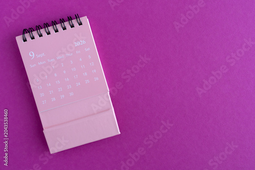 Hello September, desk calendar for planning for August 2026 on a pink background
