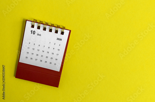 Hello October, desk calendar for planning for August 2026 on a yellow background