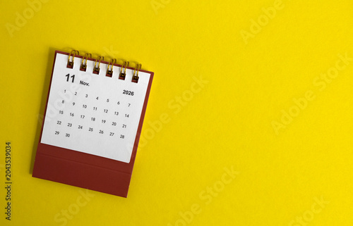Hello November. Desk calendar for planning for August 2026 on a yellow background