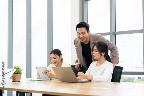 A group of professionals engage in a collaborative meeting in a modern office. The scene highlights teamwork, leadership, dynamic communication in a productive corporate environment.
