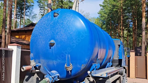 Sewage tanker truck. Blue sewage truck. Truck with blue septic tank. Industrial transport theme