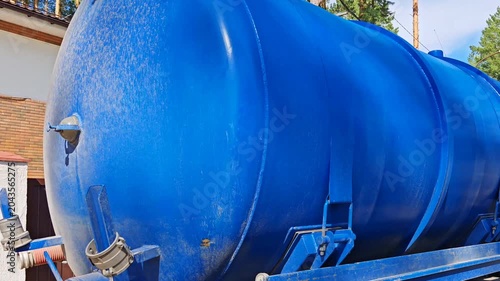 A sewage truck operating in a rural environment
