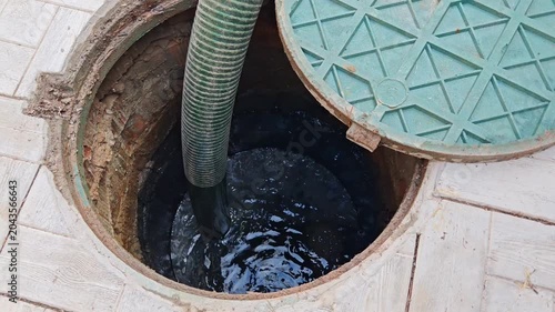 Septic tank. Pipe in a drainage pit. Pumping wastewater from a septic tank. Septic tank maintenance.
