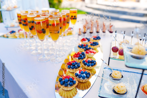 Luxury dessert buffet with fruit tartlets and drinks