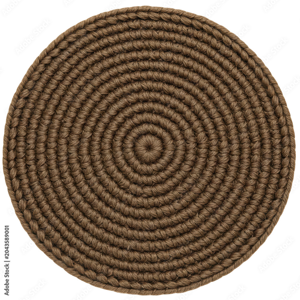 Fototapeta premium Circular brown braided placemat with concentric pattern and textured surface isolated on white background