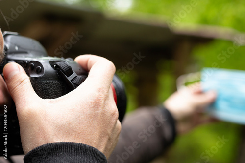 photographer taking photo with camera in nature, closeup