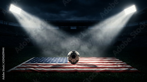 American soccer field with ball and flag under lights