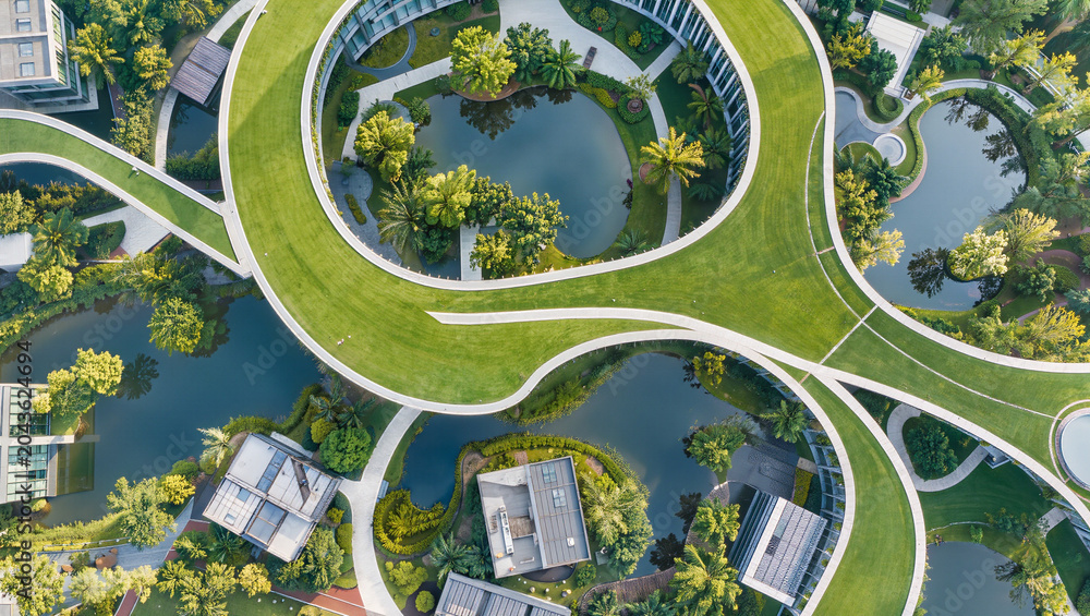 Fototapeta premium Aerial View of Modern Green Architecture with Curved Roofs and Ponds